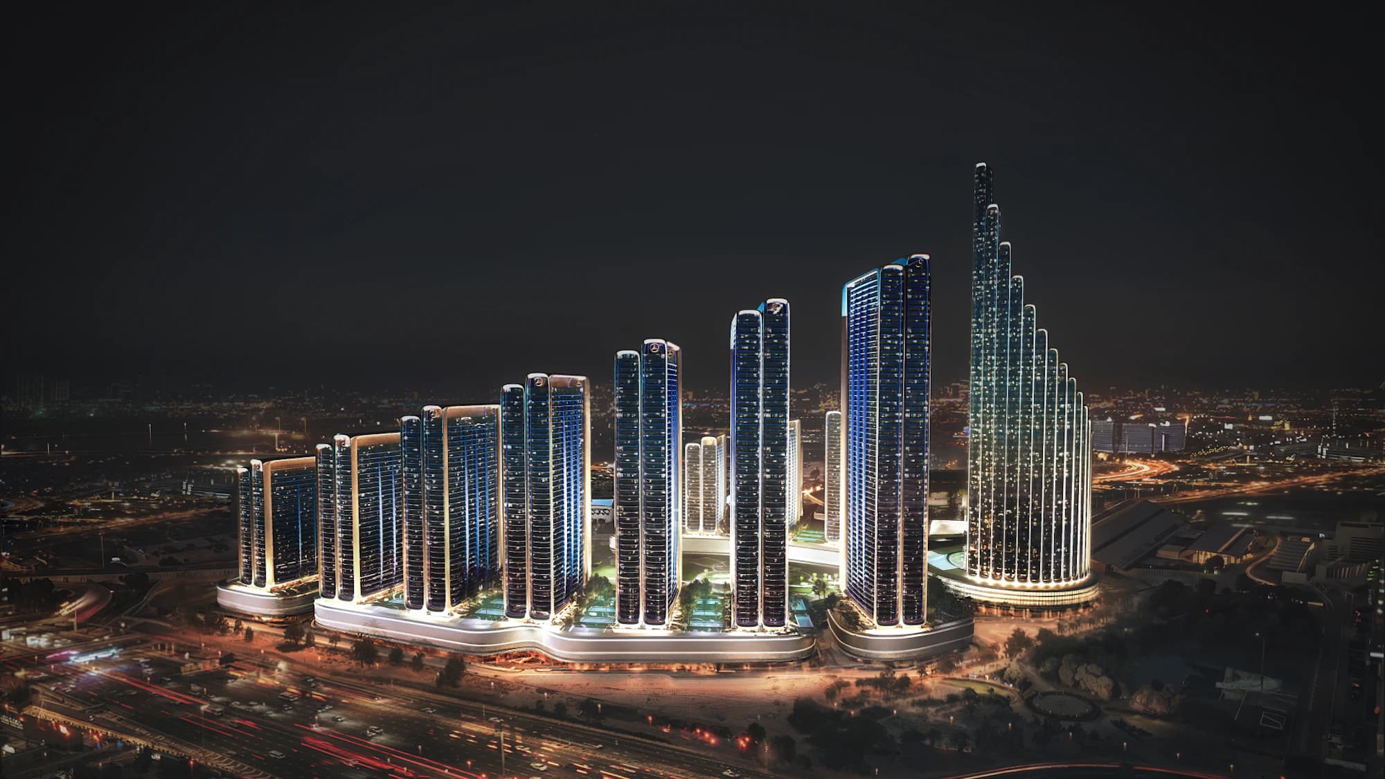 The twelve towers of Binghatti City lit up at night
